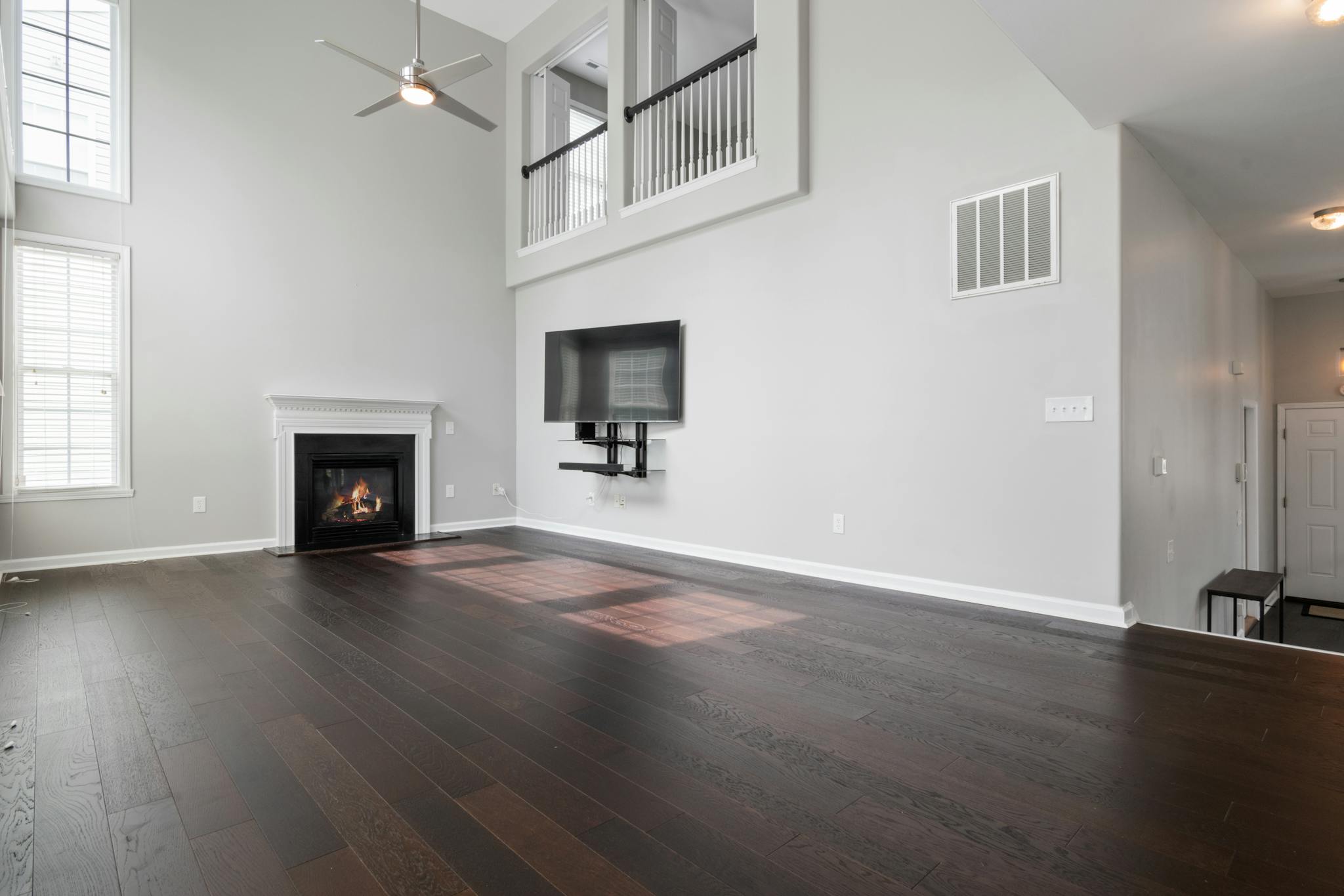 Bright and modern living room featuring a fireplace and mounted TV, perfect for contemporary homes.
