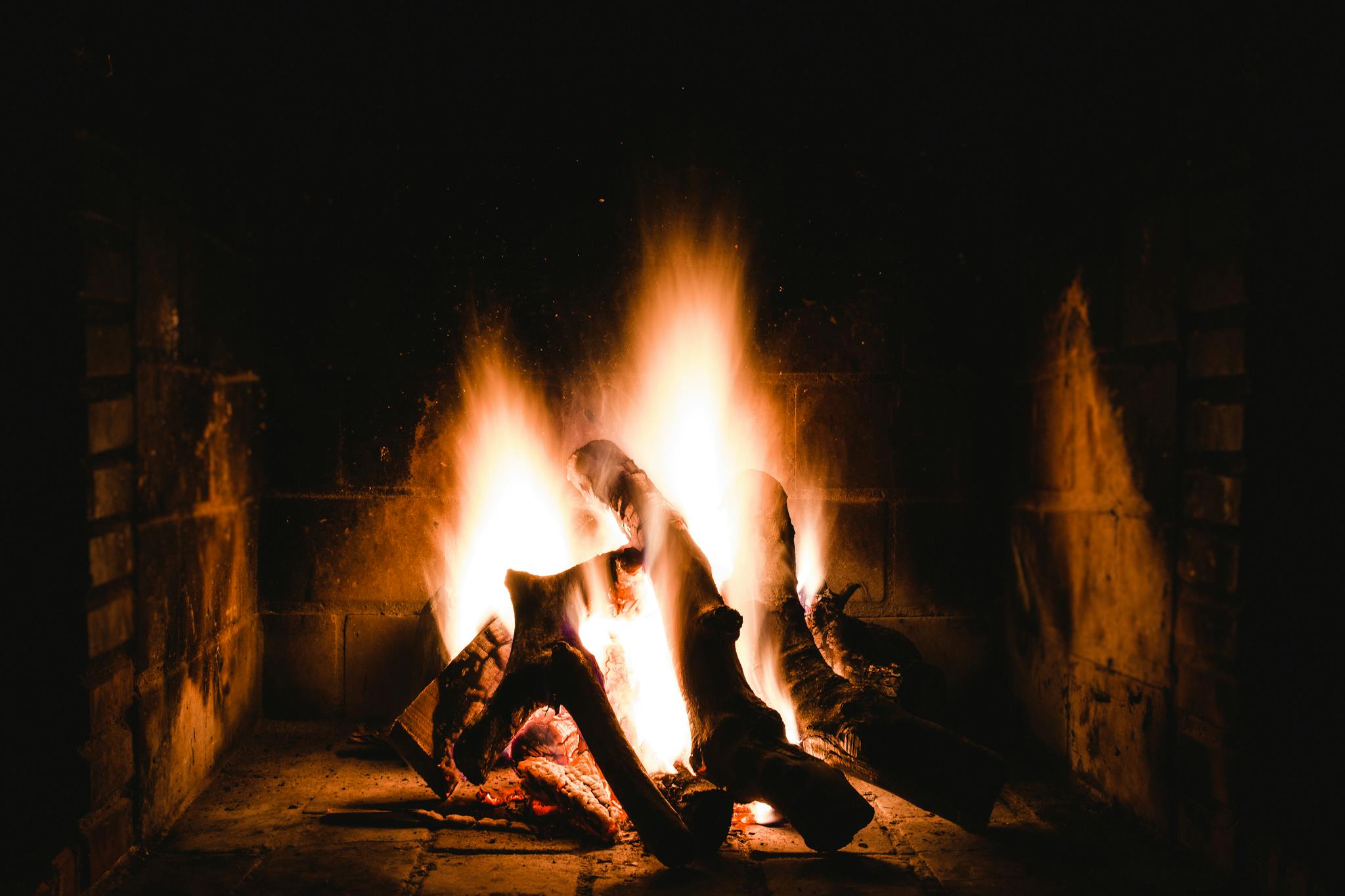 Warm and inviting fireplace with burning logs providing a comforting ambiance.